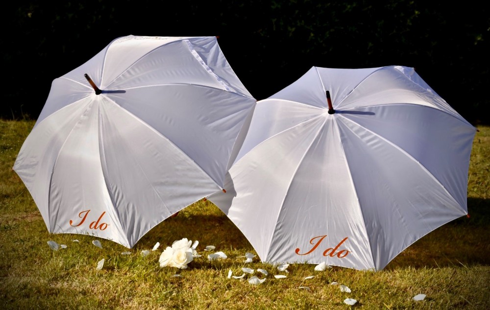 White umbrella with the words I Do